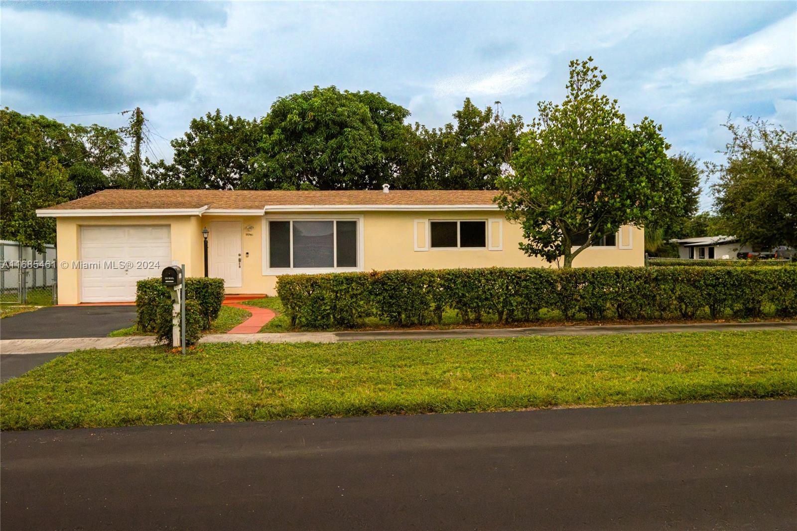 a view of a house with a yard and a garden