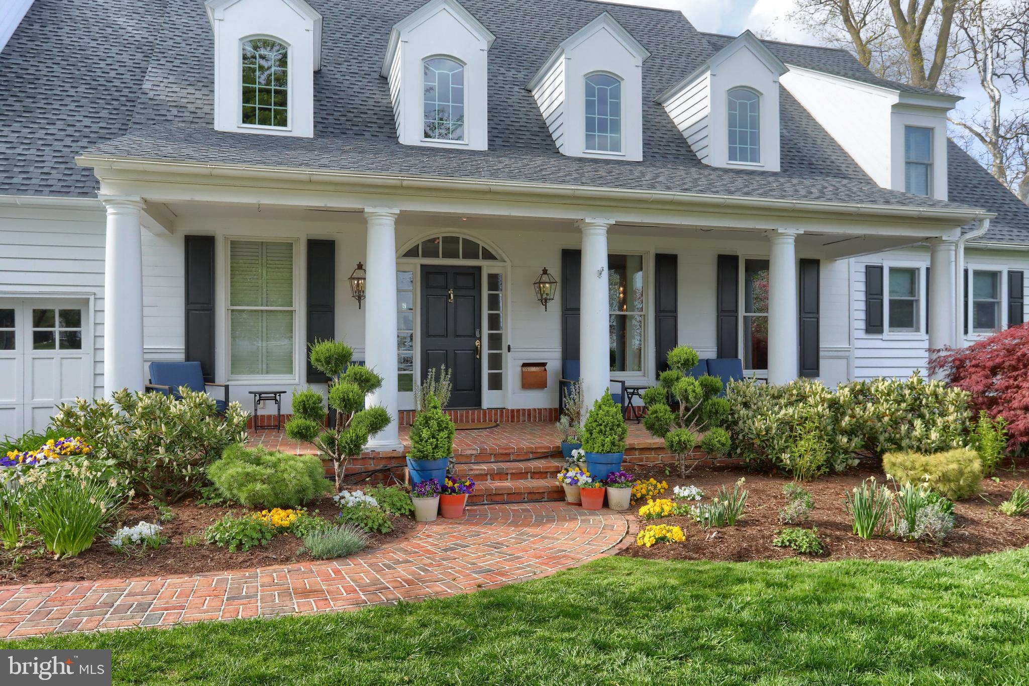 front view of a brick house with a yard