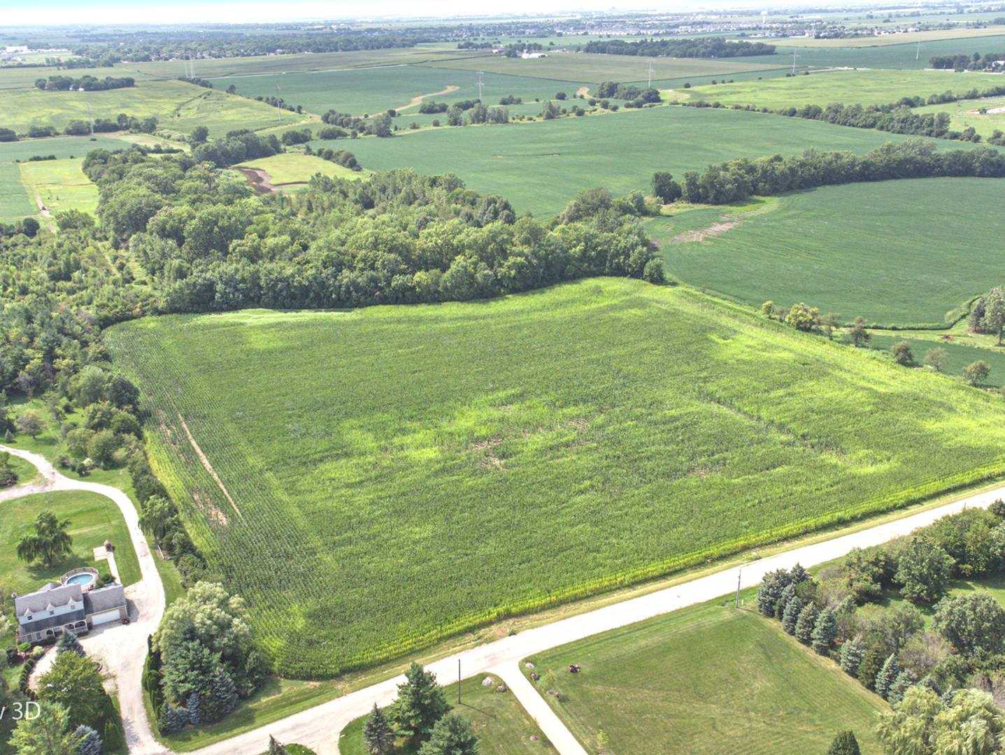 a view of a field with a lake view