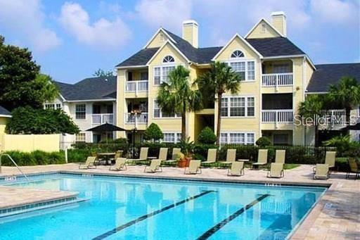 a front view of a house with swimming pool having outdoor seating