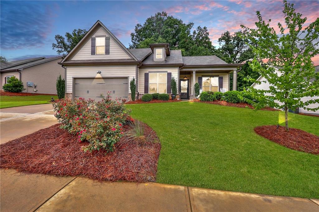 a front view of a house with a yard and garage