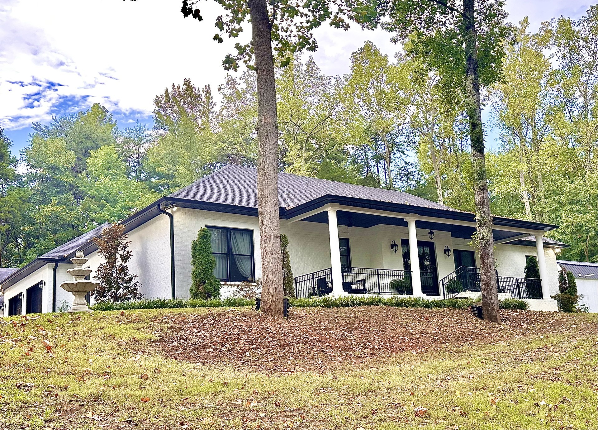 a front view of a house with garden