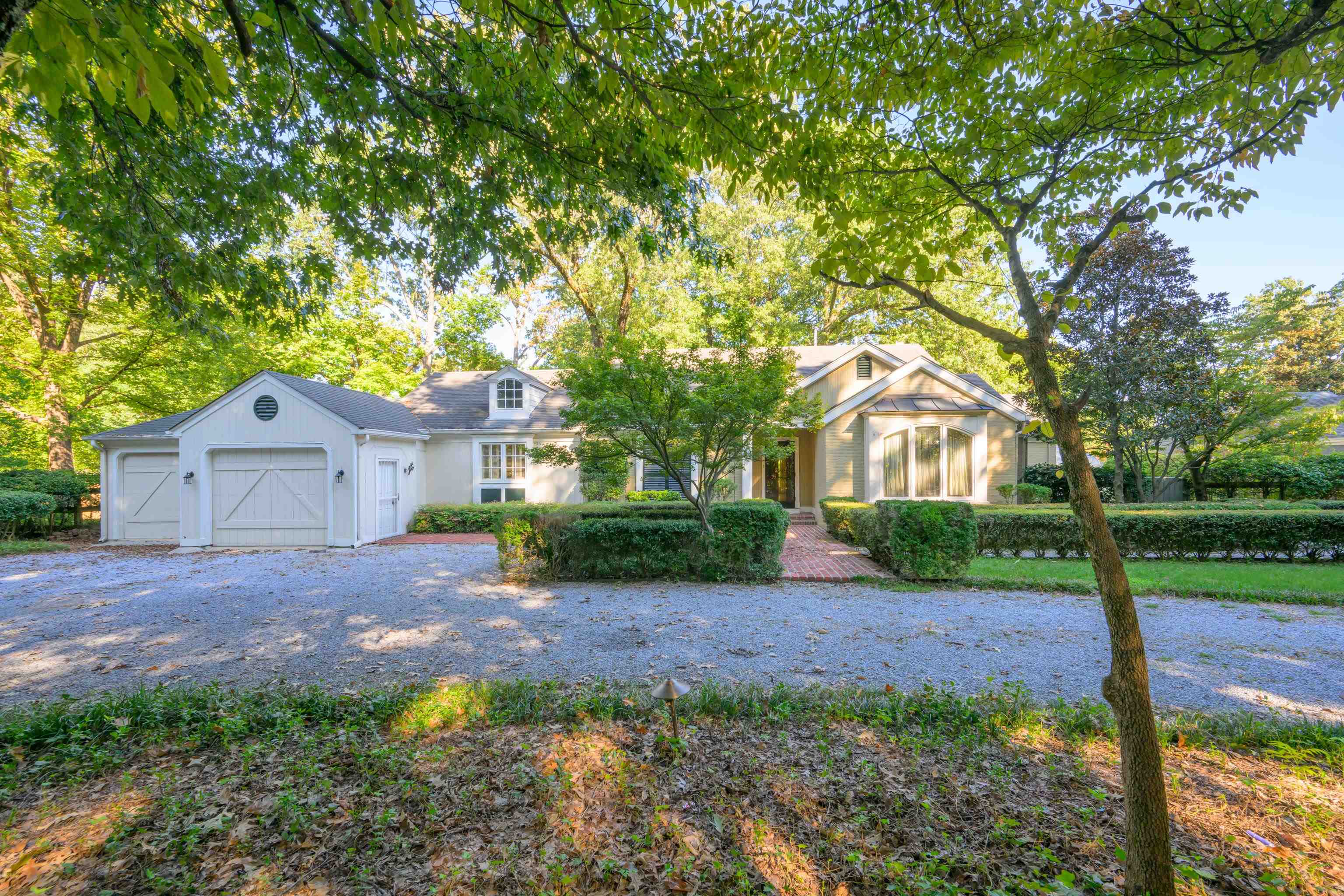 a view of a house with a yard and tree s