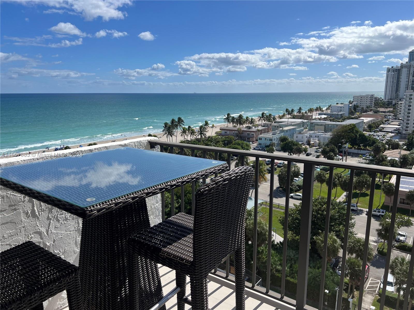 a view of a balcony with an outdoor seating