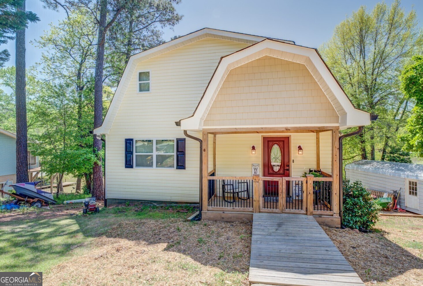 a view of a house with backyard porch and sitting area