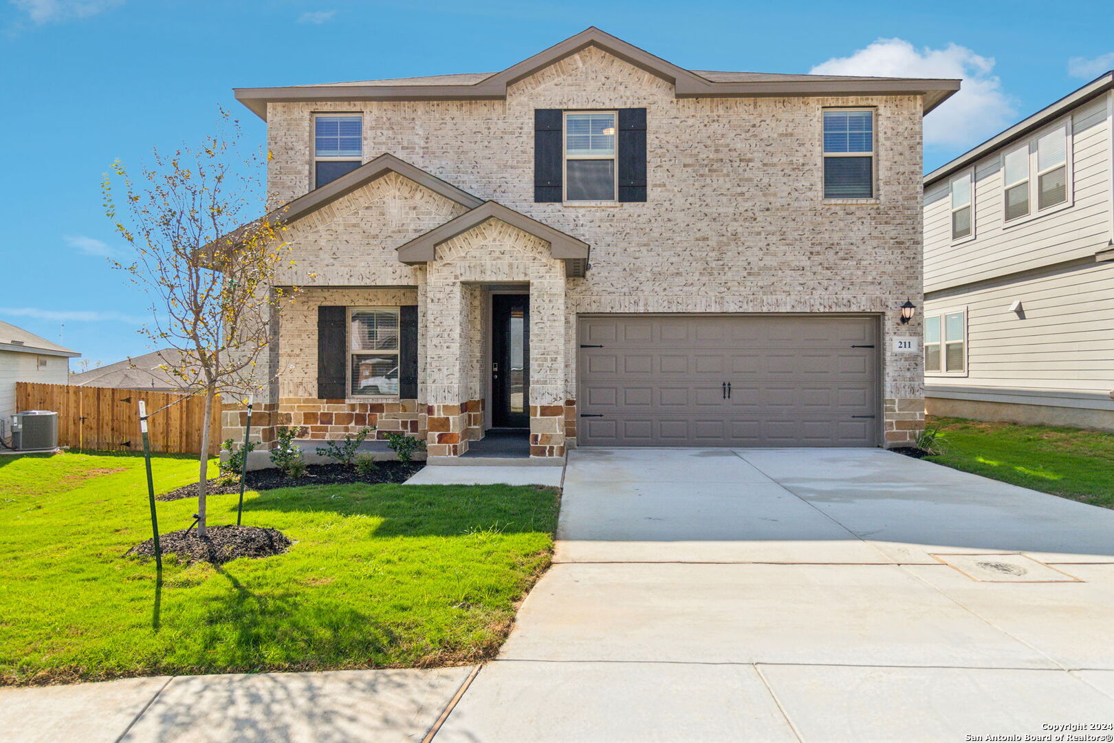 a front view of a house with a yard