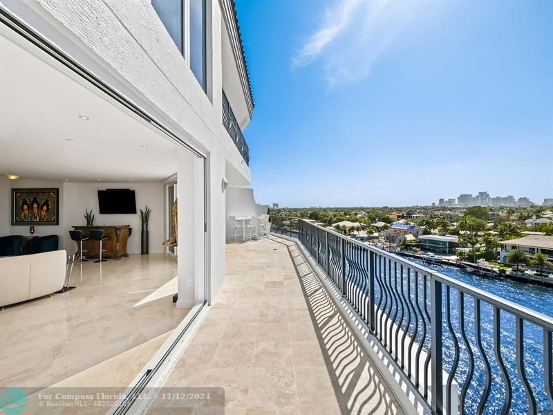 a balcony with furniture and city view