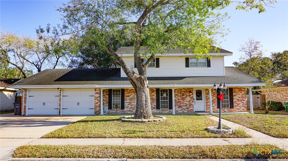 front view of a house with a tree