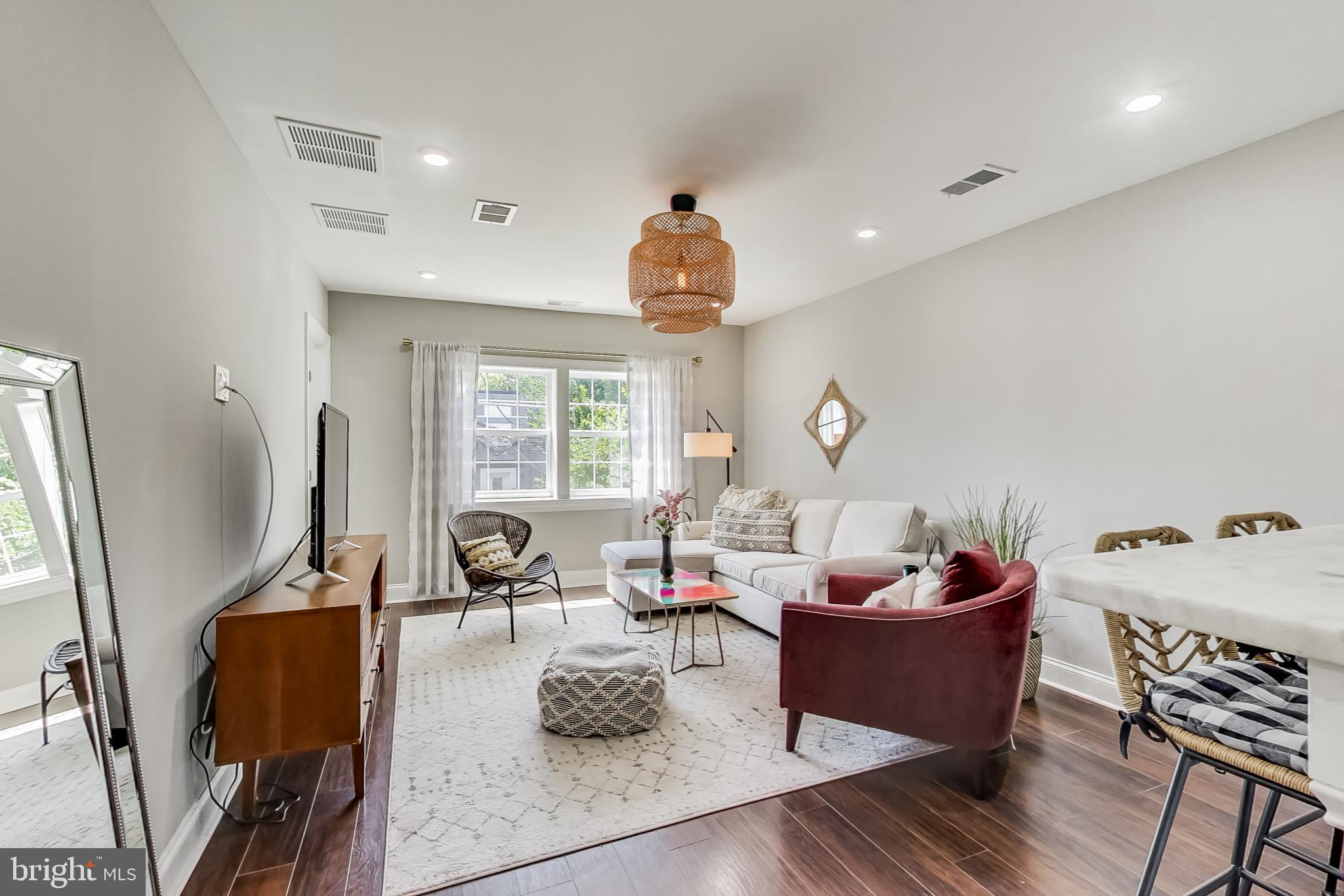 a living room with furniture a window and gym equipment