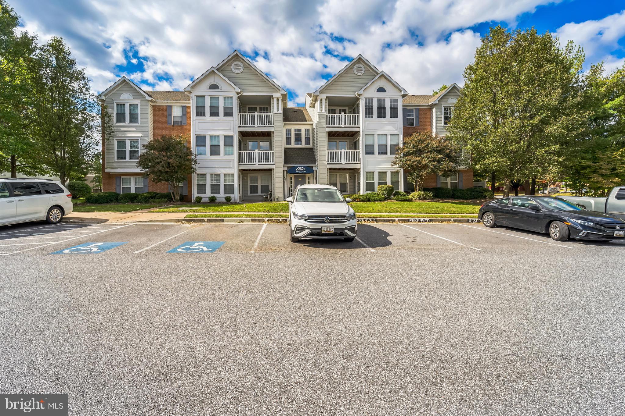 a front view of a residential apartment building with a yard