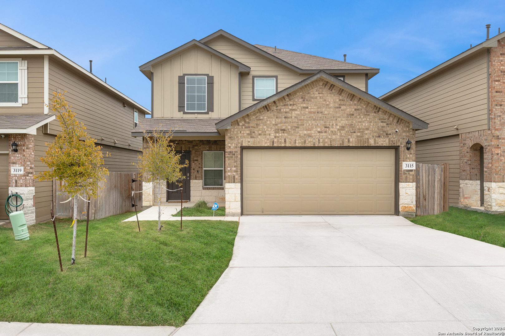 a front view of a house with a yard and garage