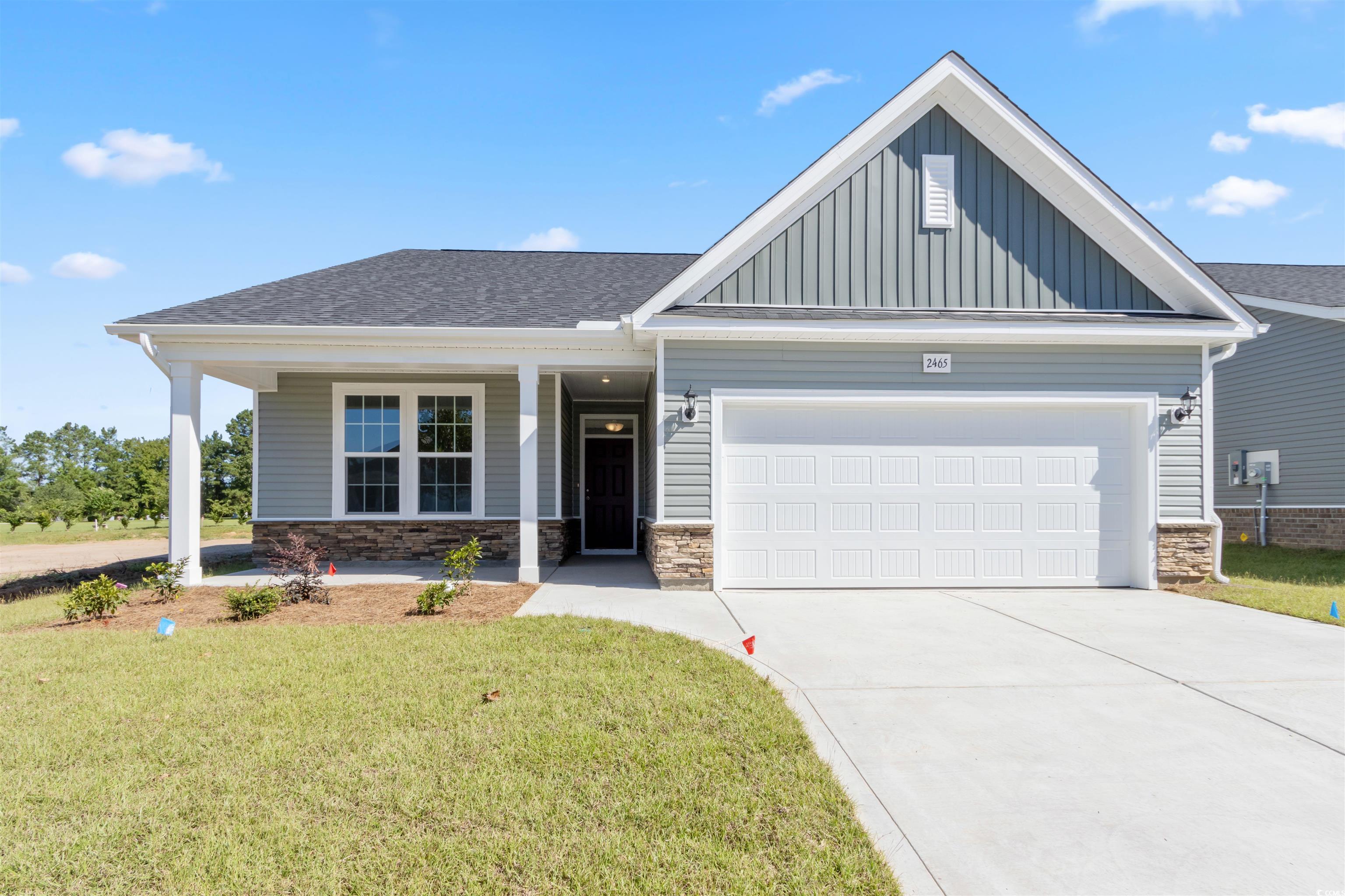 Craftsman house featuring a front lawn, a garage,