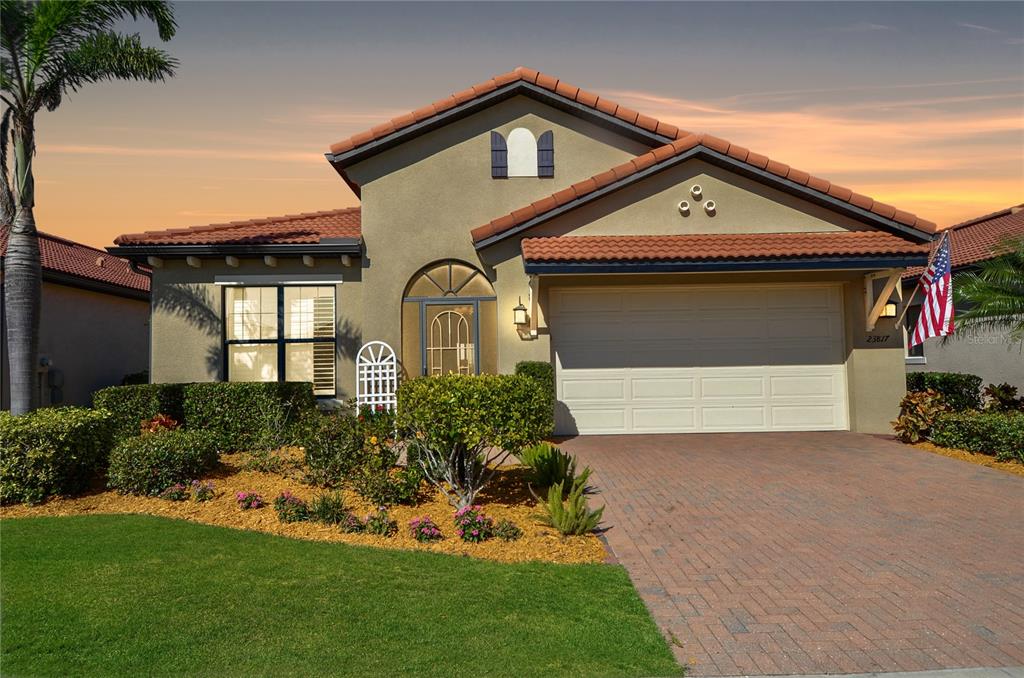 a front view of a house with a yard and garage