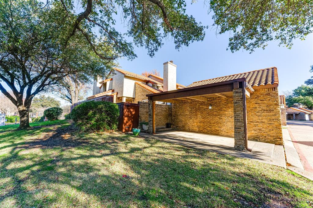 a view of a house with a tree in the yard