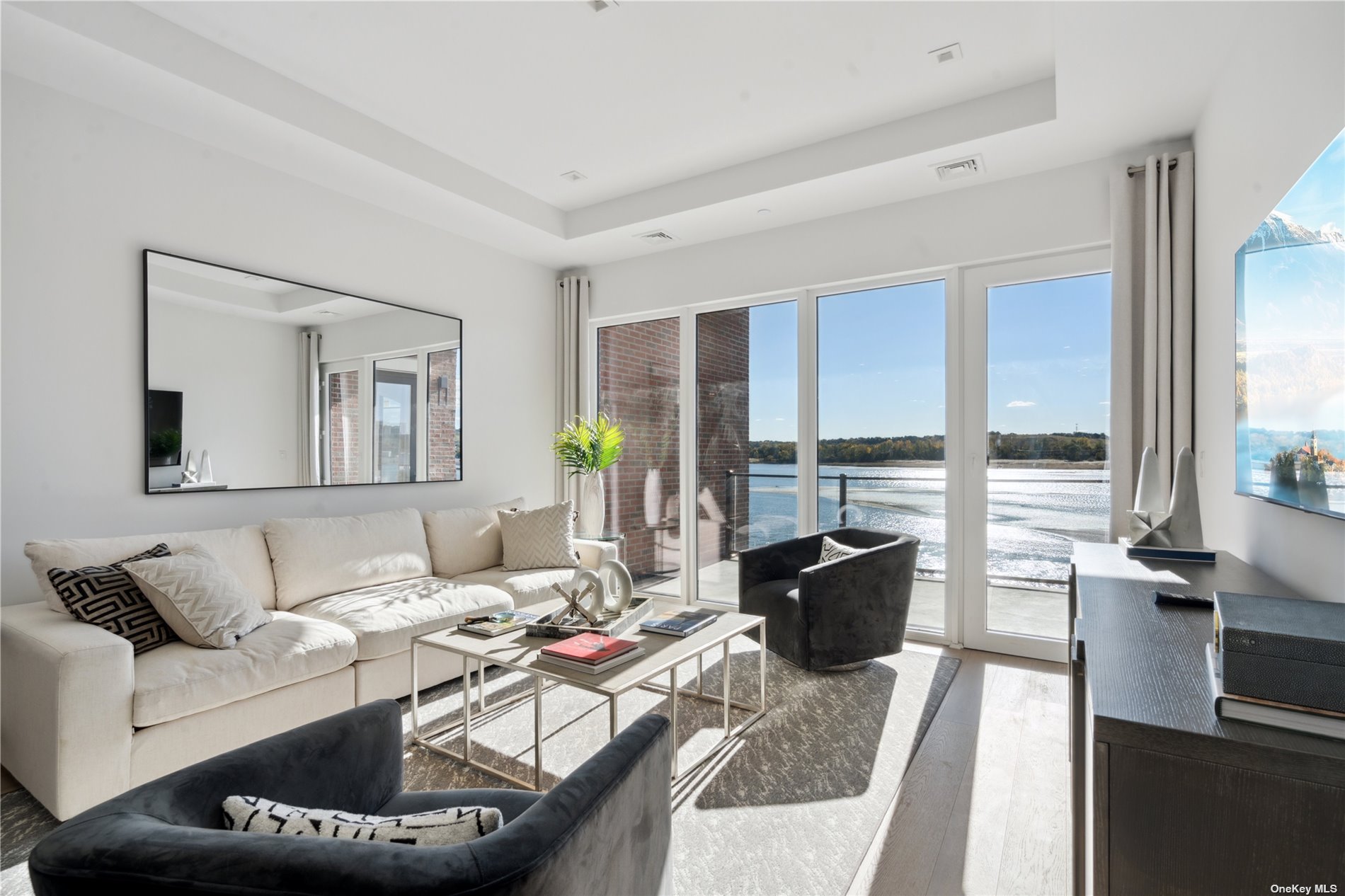 a living room with furniture and floor to ceiling window