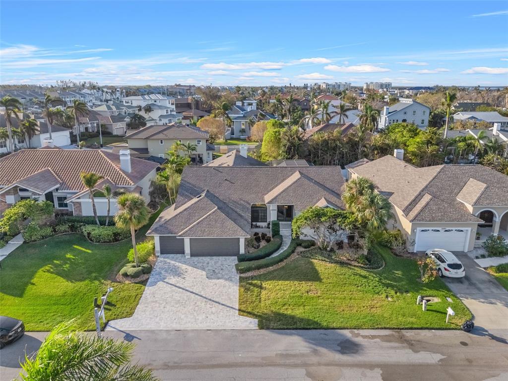 an aerial view of residential houses with outdoor space and ocean view