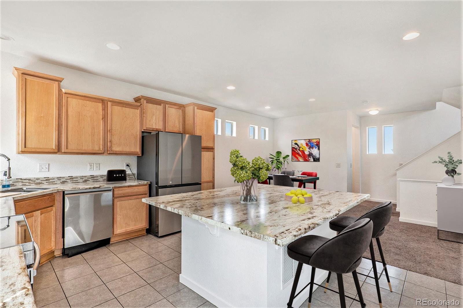 a kitchen with granite countertop sink cabinets and stainless steel appliances