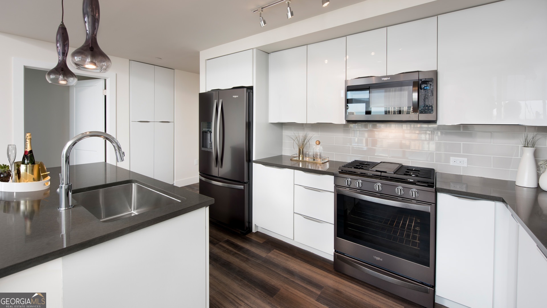 a kitchen with white cabinets and stainless steel appliances