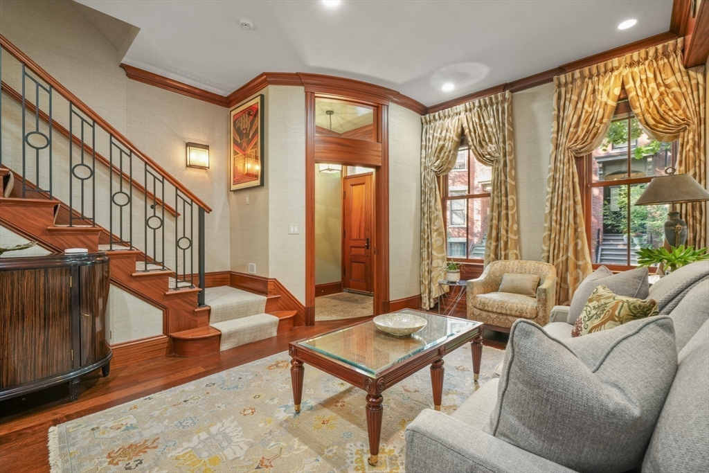 a living room with furniture a table and a large window