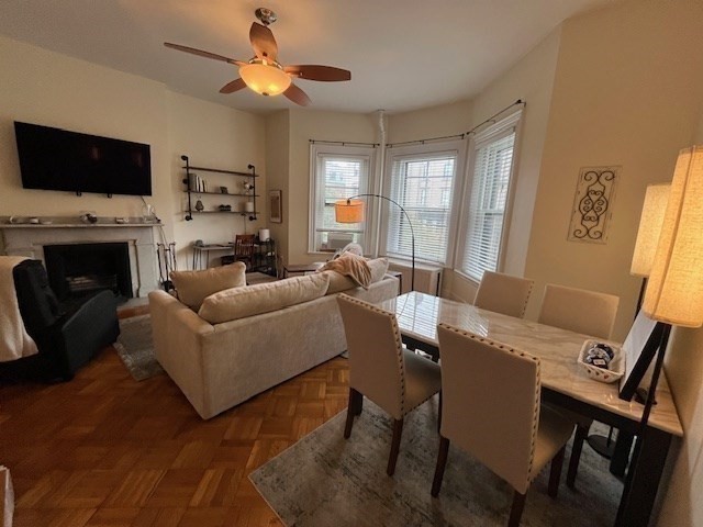 a living room with furniture a fireplace and a flat screen tv