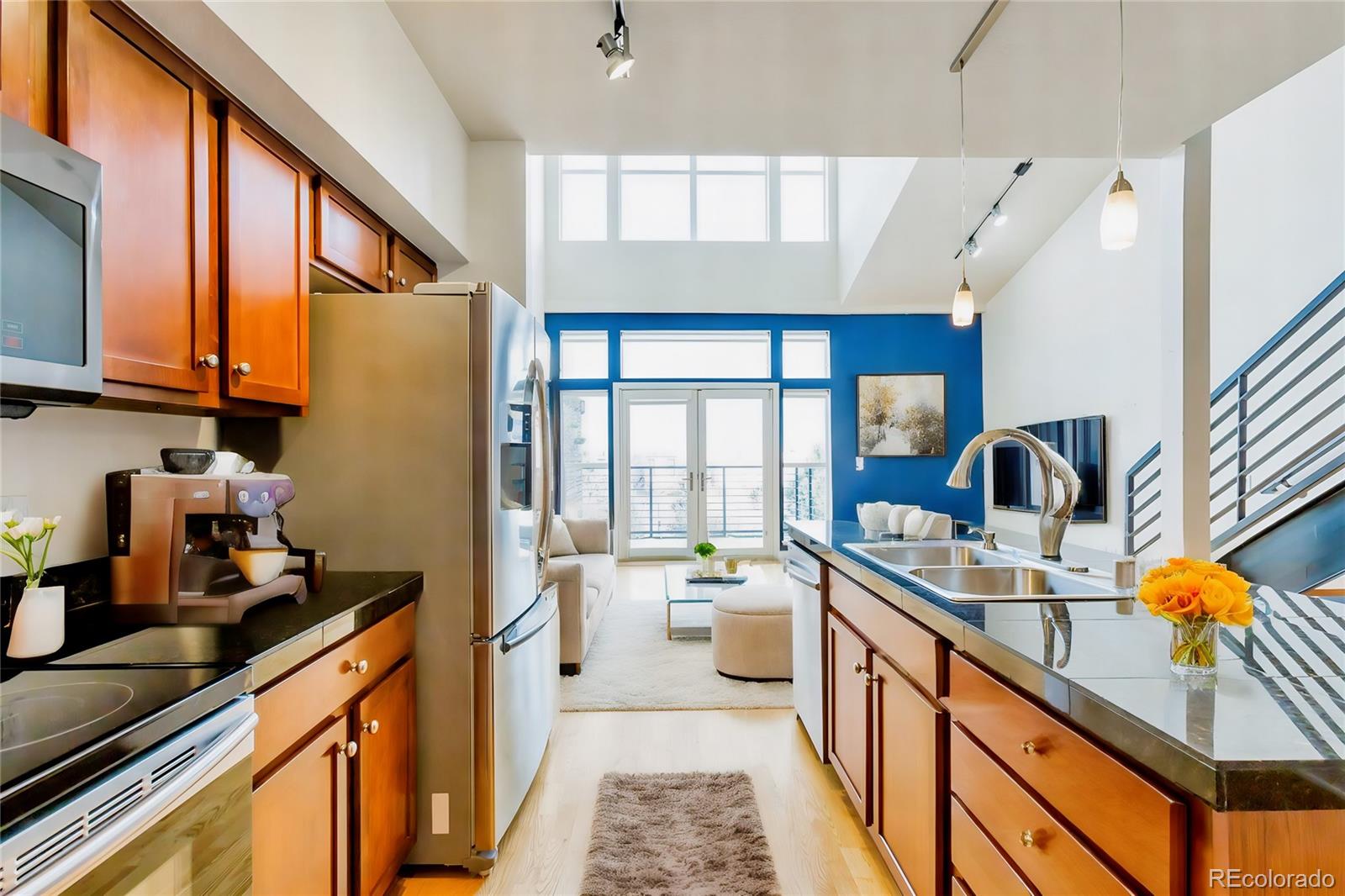 a kitchen with stainless steel appliances granite countertop a sink stove and cabinets