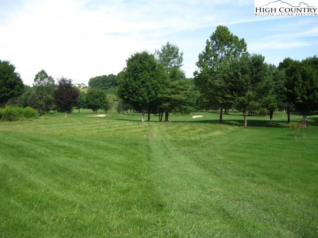 a view of grassy field with benches