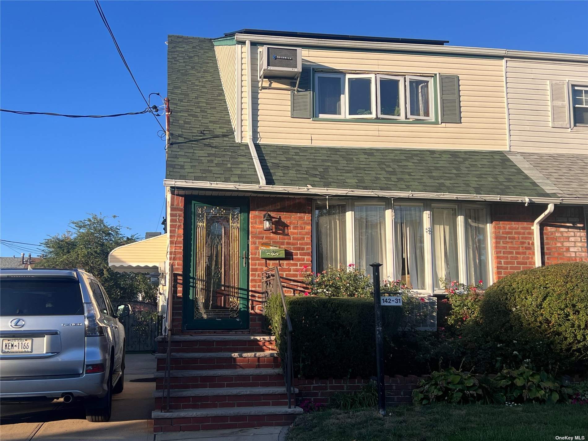 a front view of a house with a garden