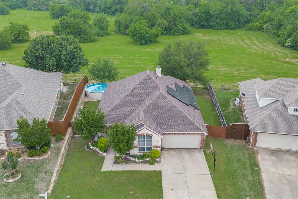 an aerial view of a house with a yard