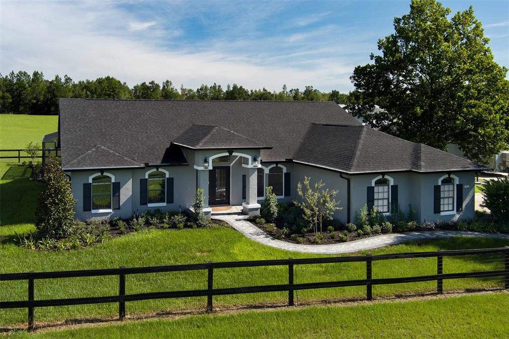 a front view of house with yard and green space