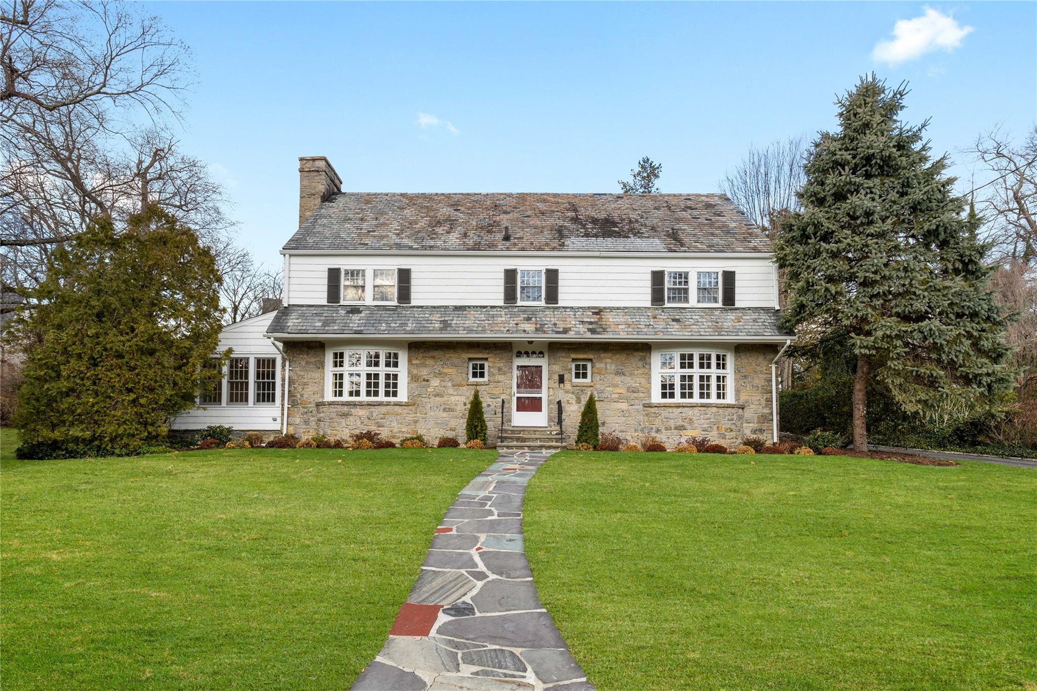 Welcome to 7 Eastwoods Lane in Scarsdale!  Beautiful stone & clapboard Center Hall Colonial.