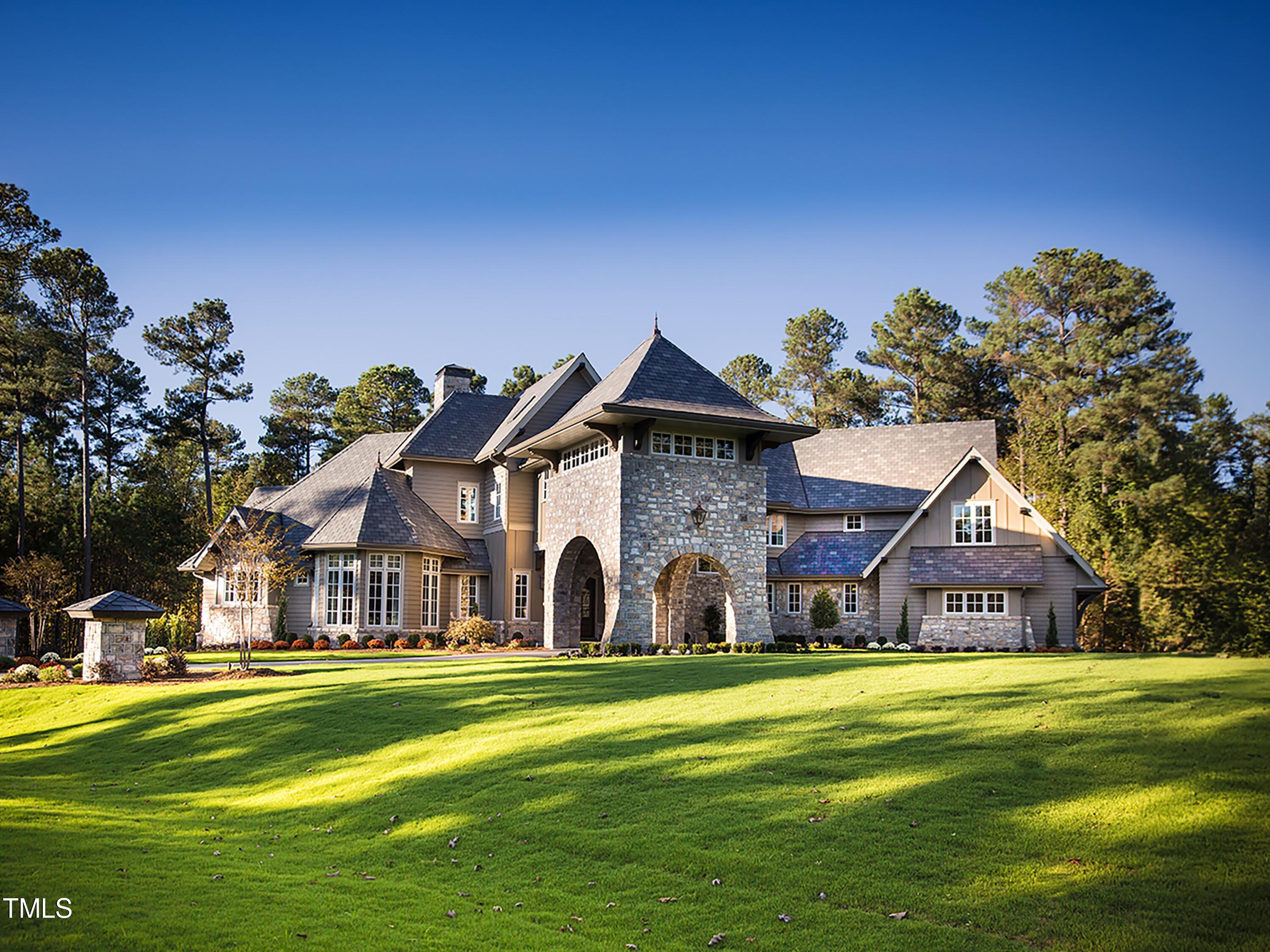 a front view of house with outdoor space and trees around