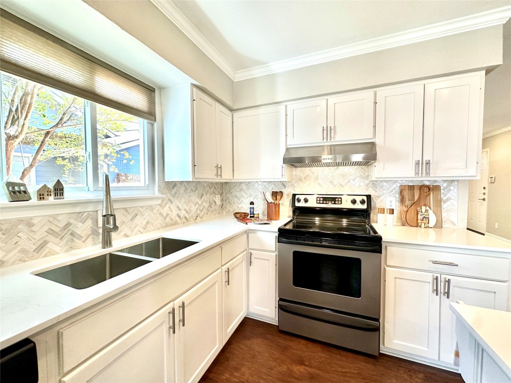 a kitchen with stainless steel appliances white cabinets and a stove