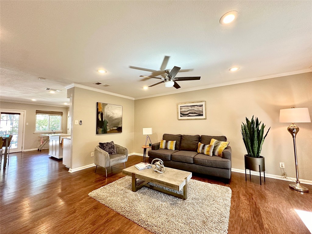 a living room with furniture and wooden floor