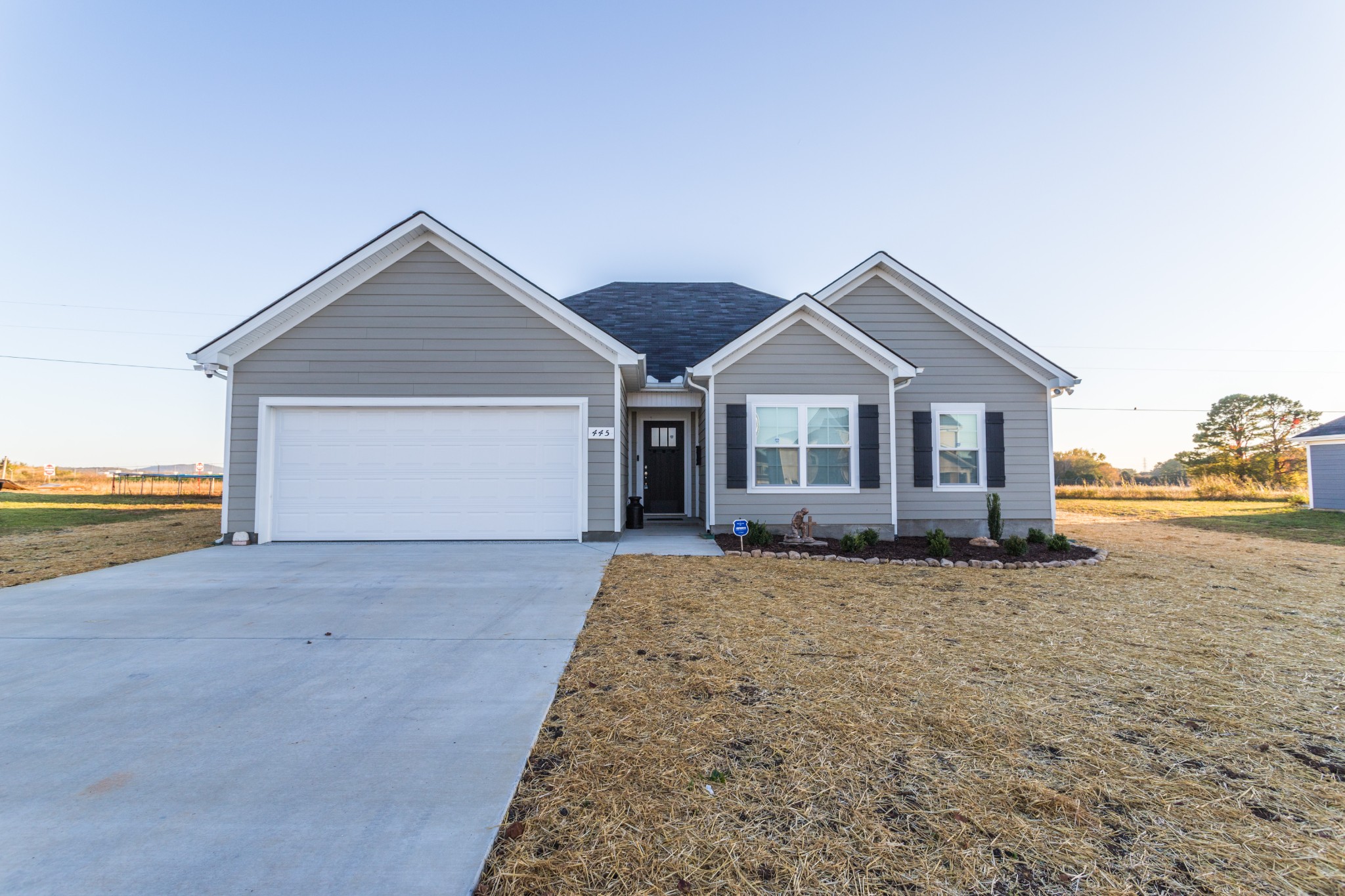 Front view with seeded lawn and new landscaping