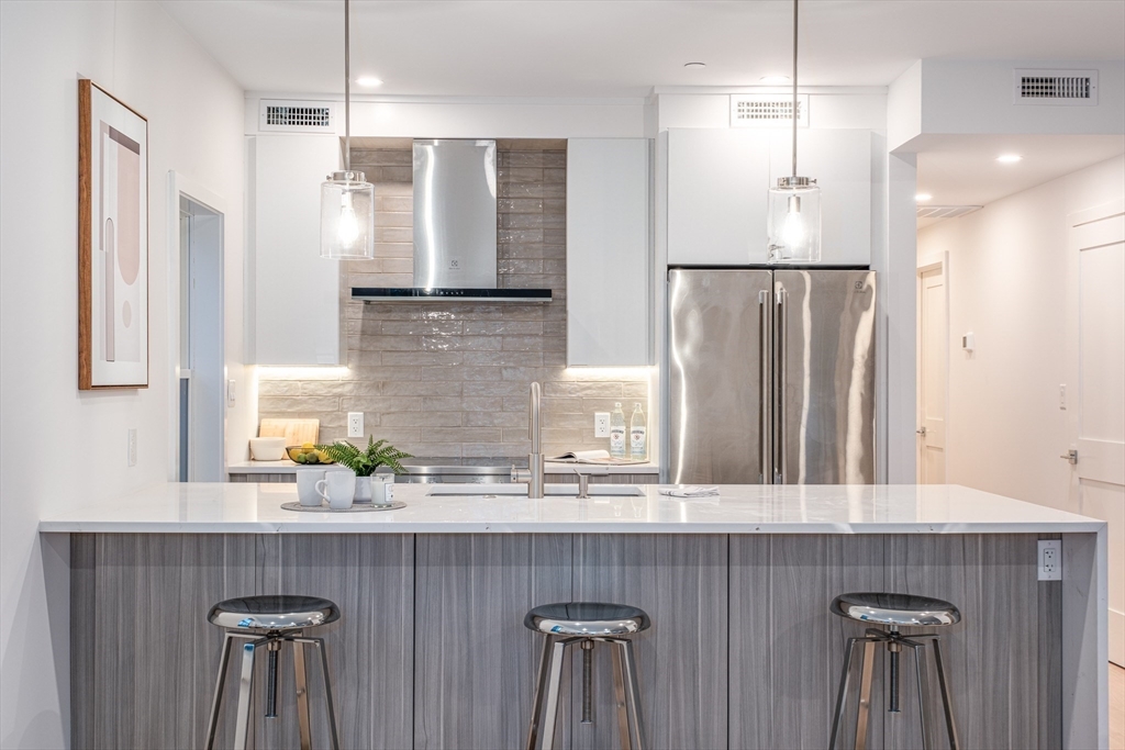 a kitchen with a sink a counter space and stainless steel appliances