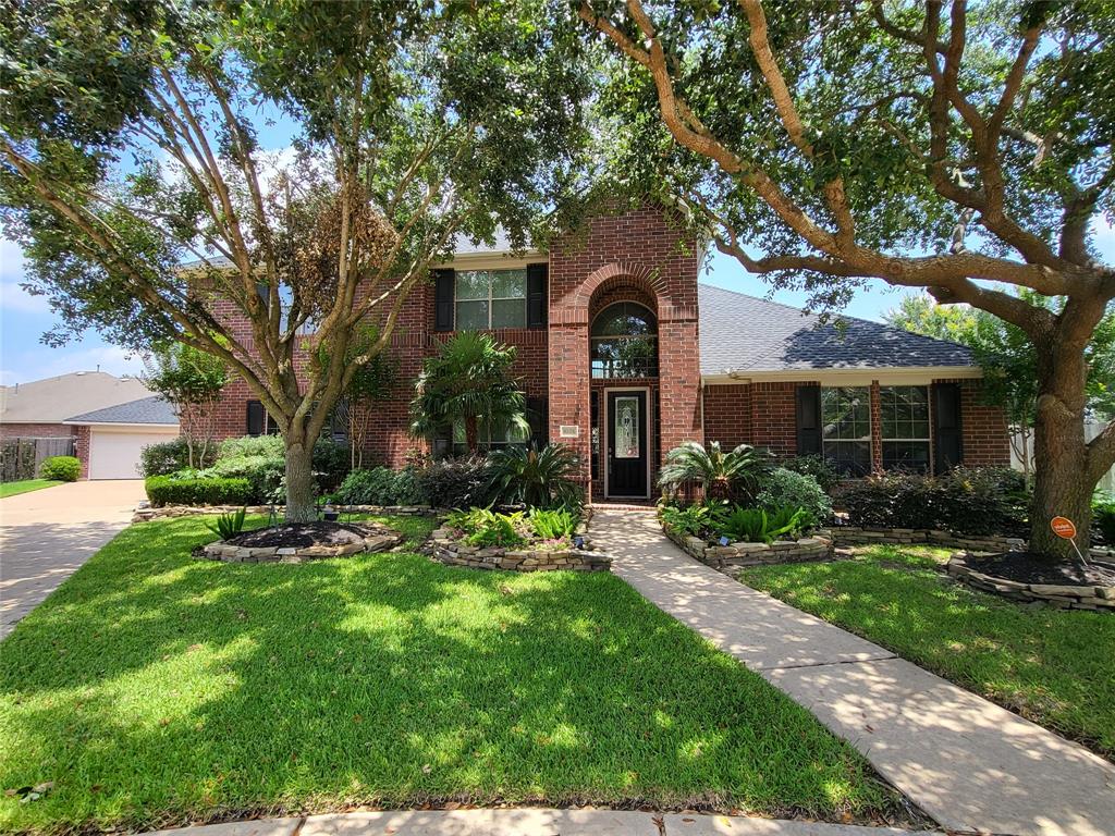 a front view of a house with a yard and porch