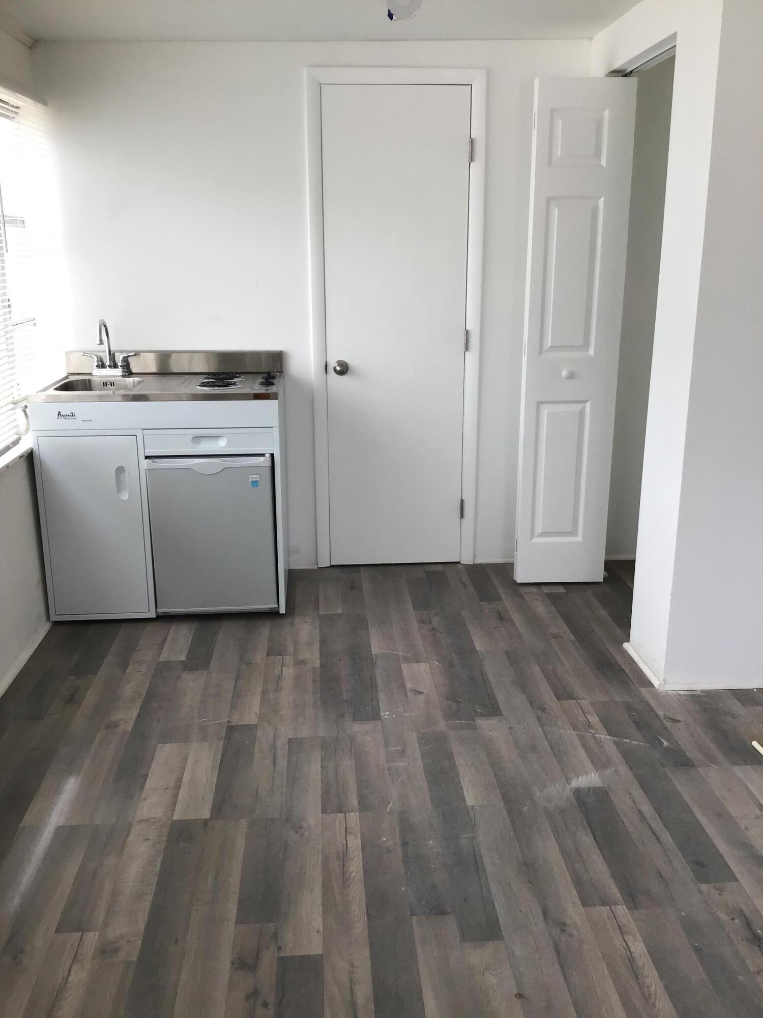 a view of a room with wooden floor