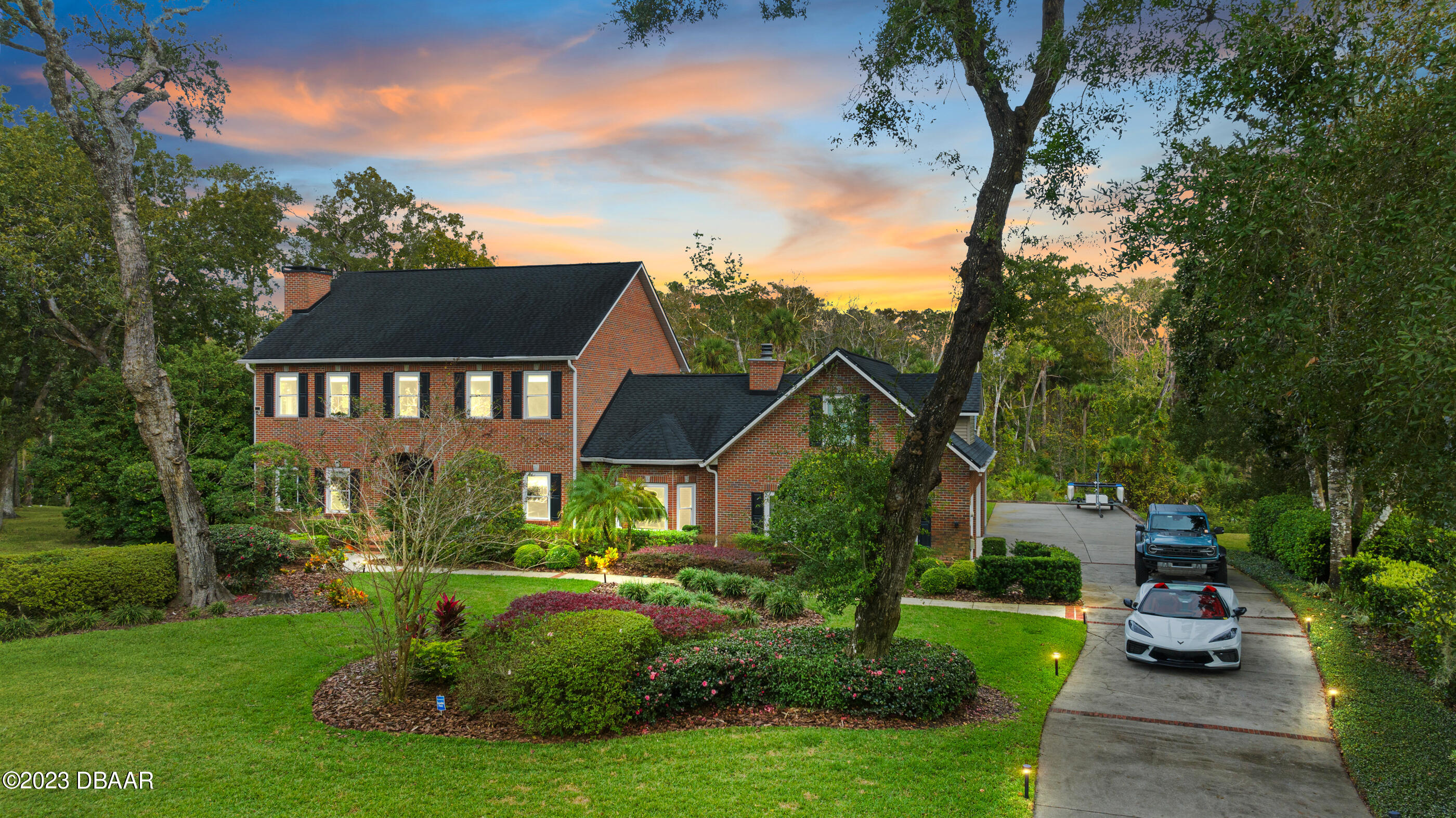 a view of a house with a yard and a garden