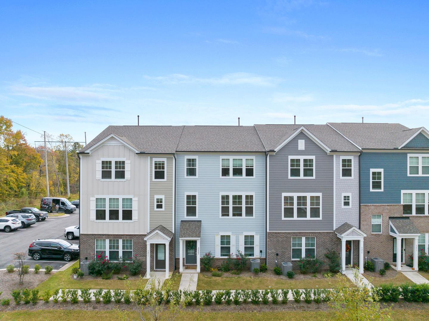 a front view of residential houses with yard