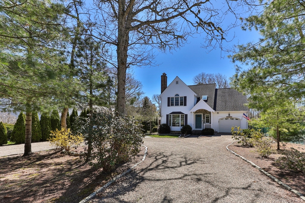 a front view of a house with a yard covered with snow