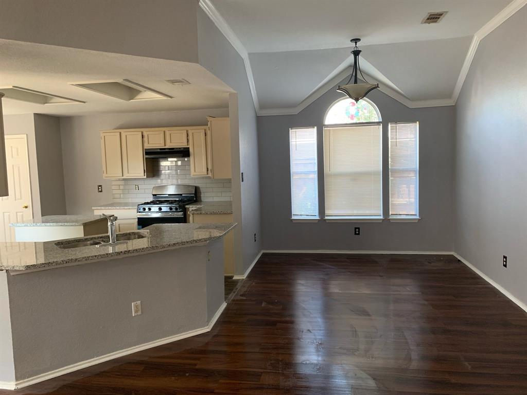 a kitchen with kitchen island a sink a window and appliances