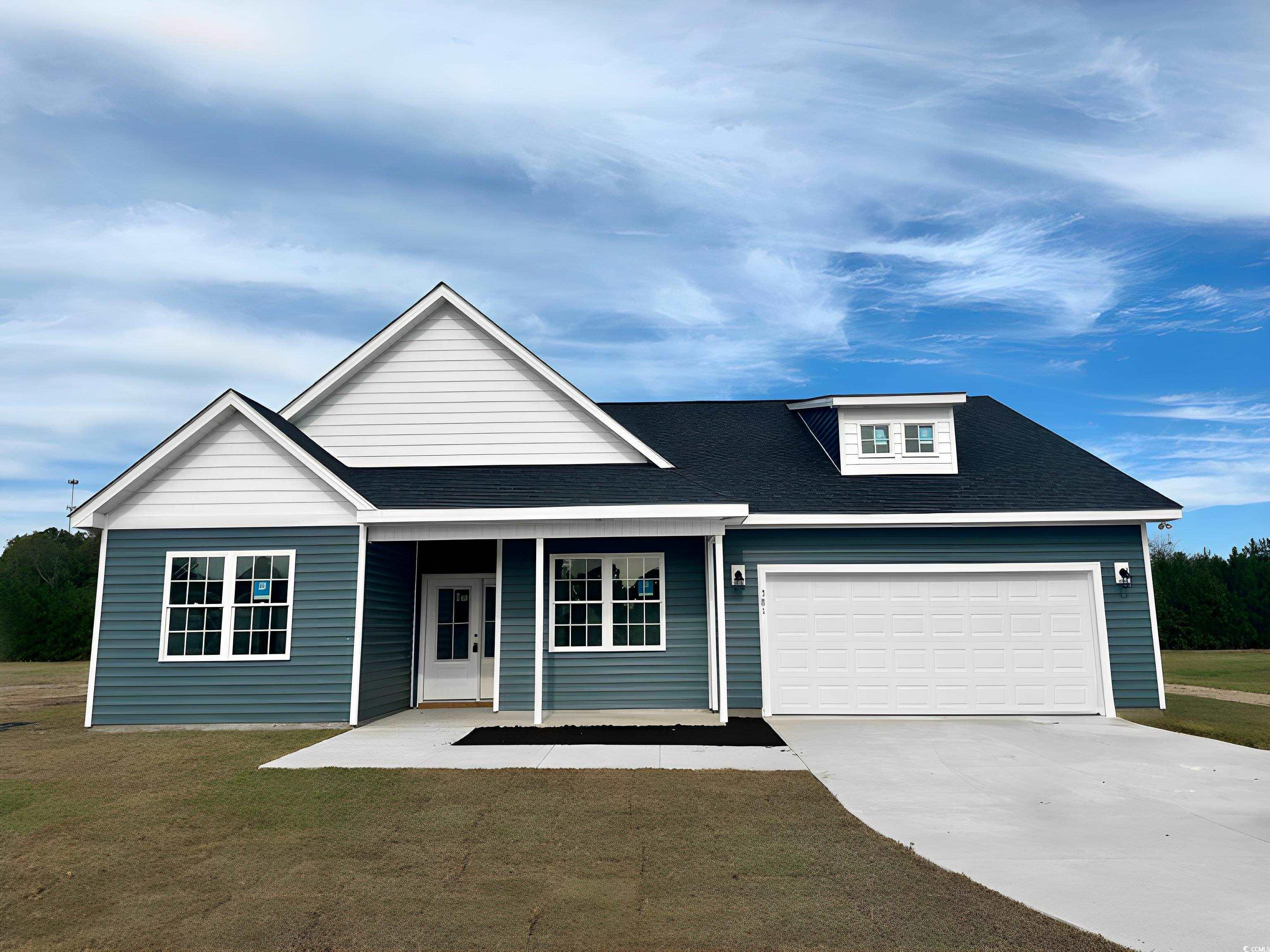 View of front of home with a garage, a front lawn,