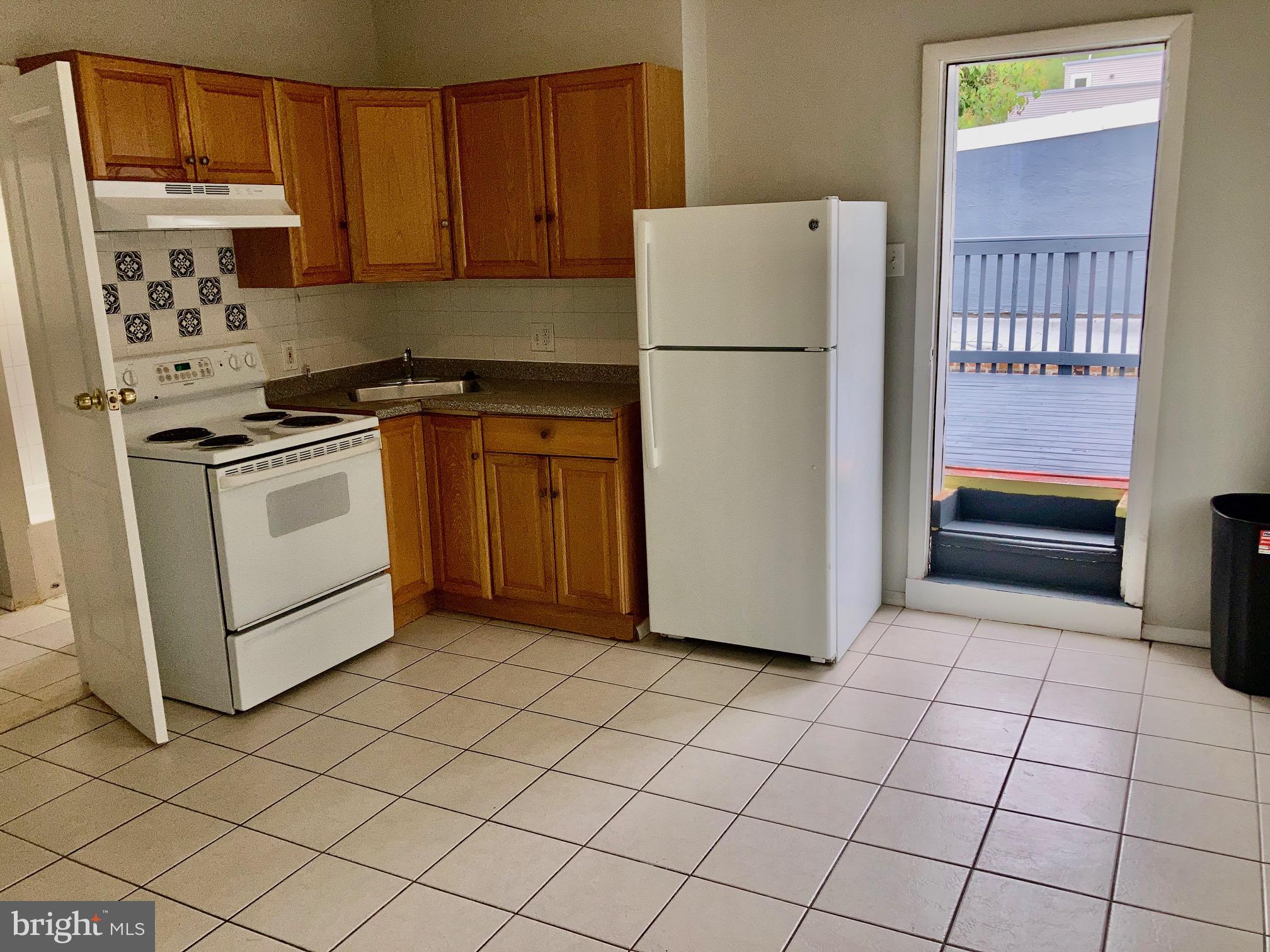 a kitchen with cabinets and white appliances