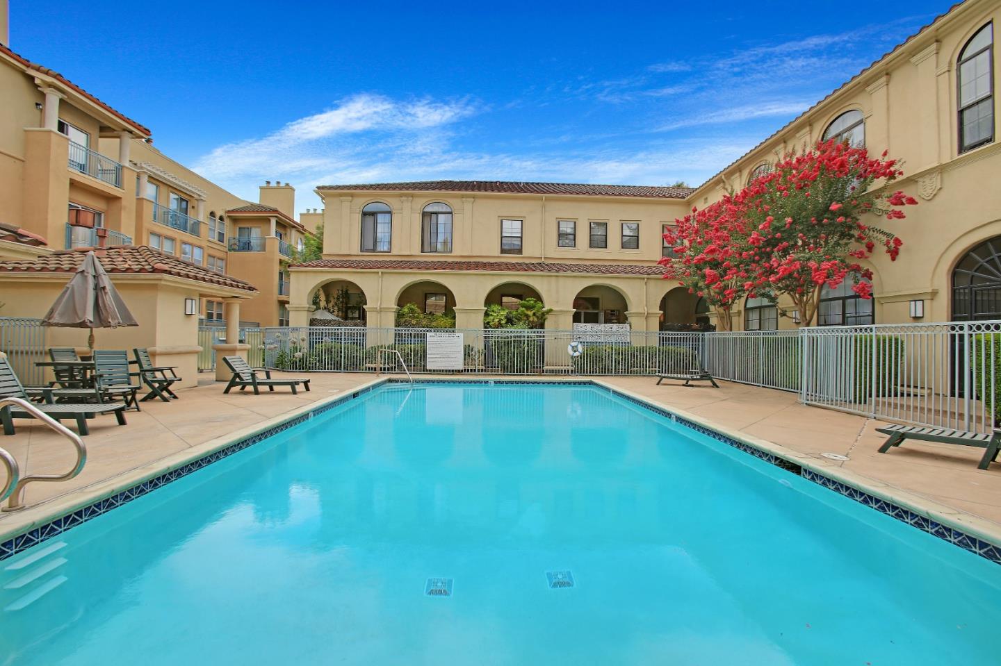 a swimming pool with outdoor seating and yard