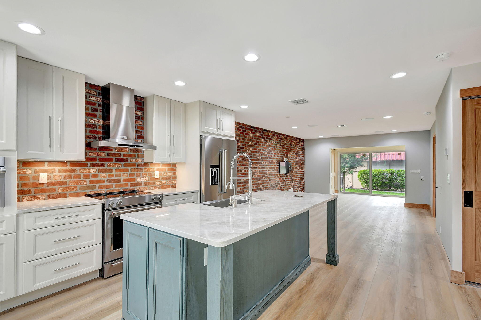 a kitchen with stainless steel appliances granite countertop a sink stove and refrigerator