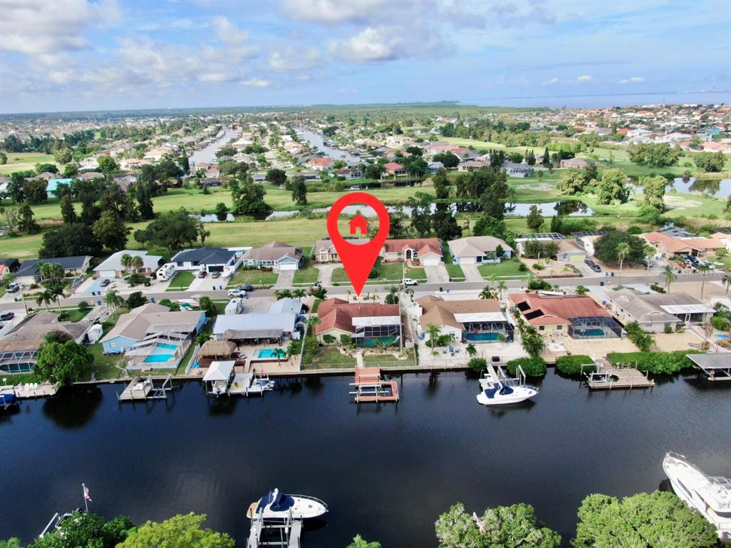 an aerial view of a houses with a lake view