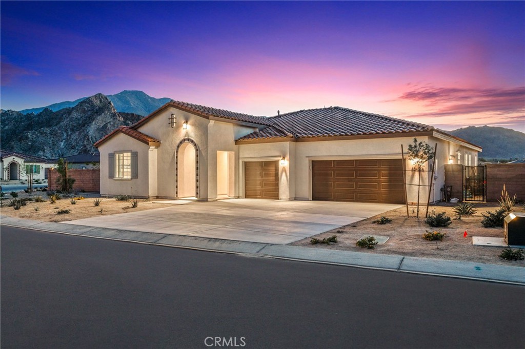 a front view of a house with yard and outdoor seating