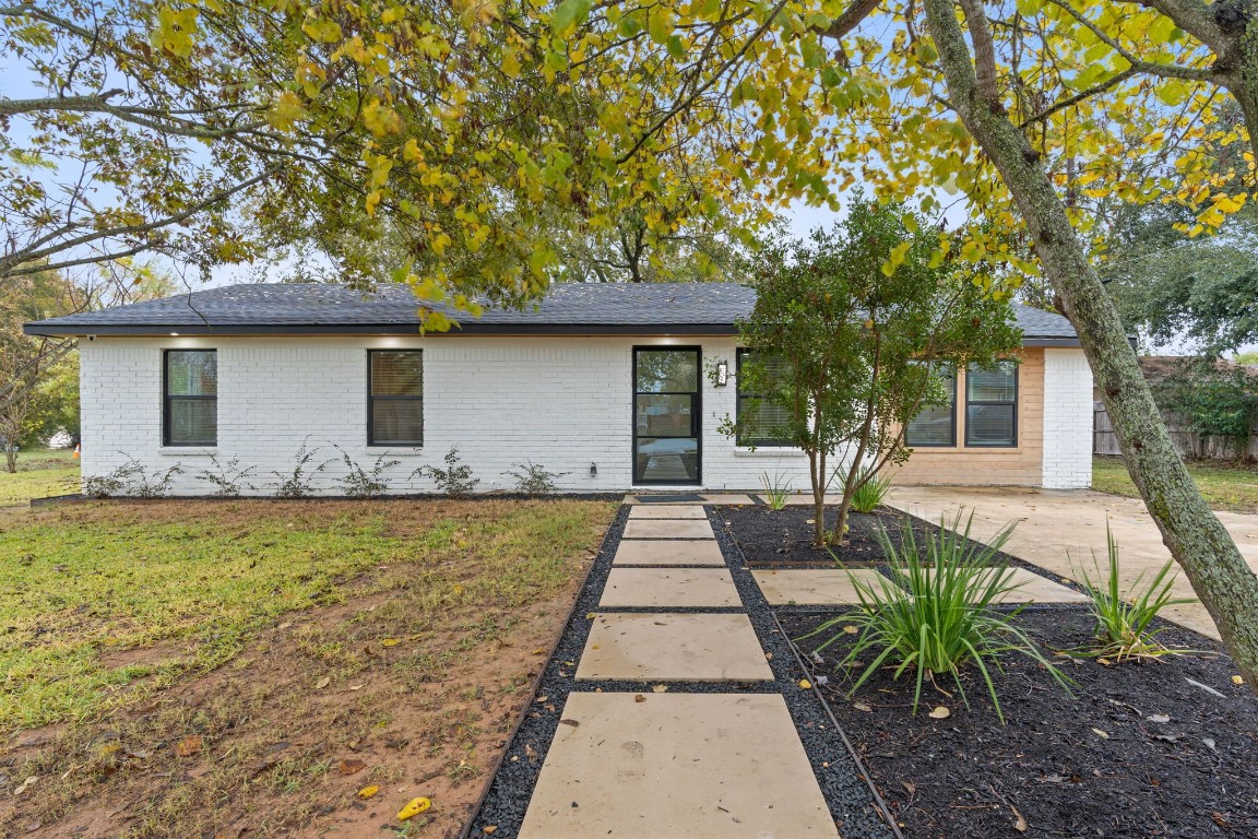 a front view of house with yard patio and green space