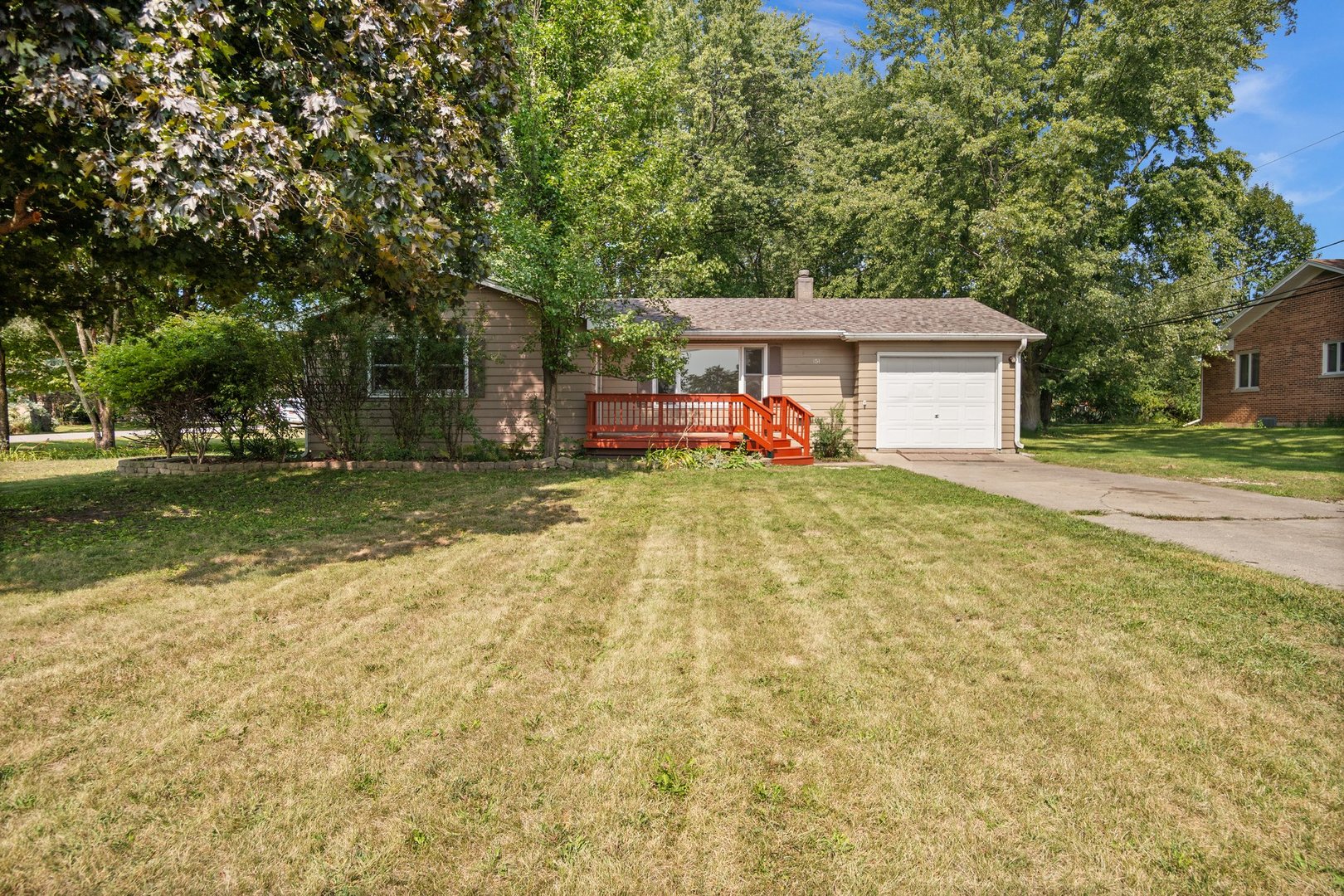 a view of a house with a yard and sitting area