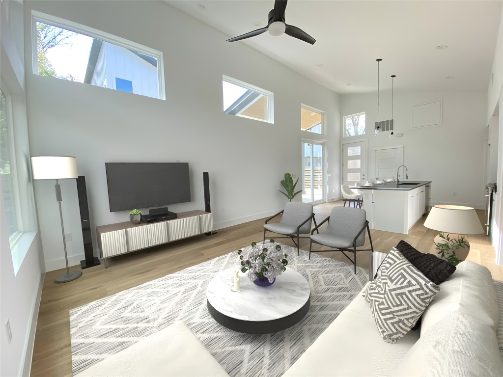 a living room with furniture and a wooden floor